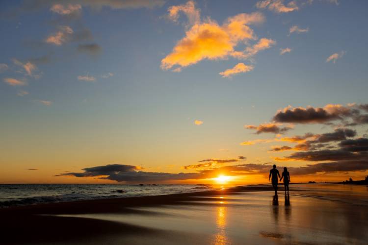 Couple holding hands on beach