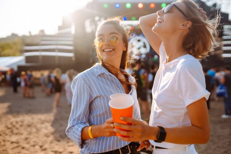 Happy women having fun at a music festival.