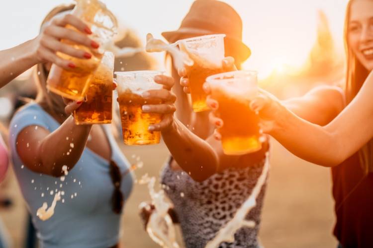 Cheering with beer at music festival.