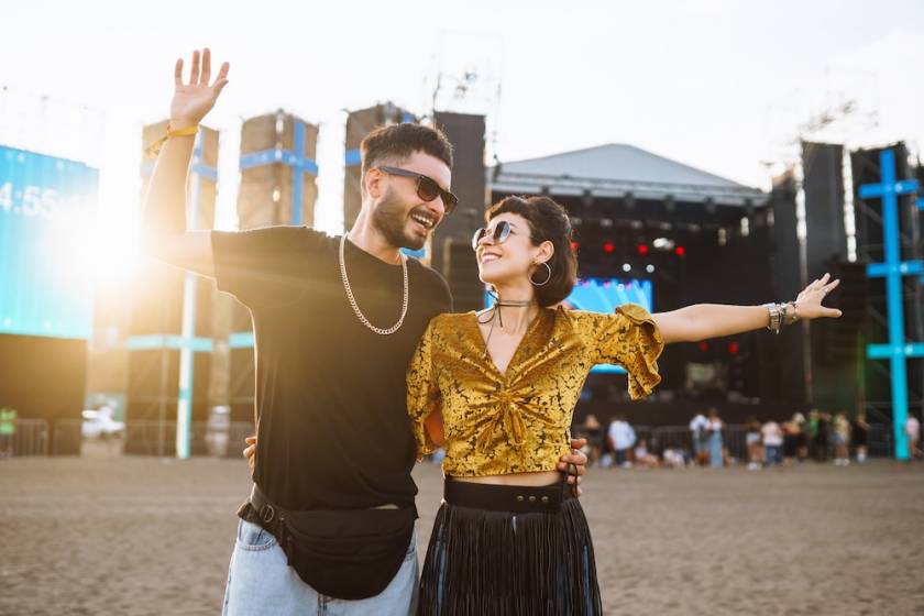 A couple at a music festival on the beach